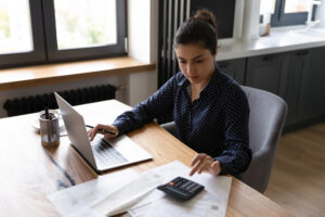 A woman managing business and personal debt.