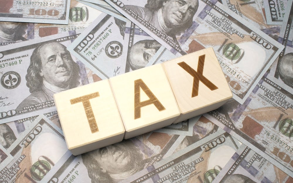 Wooden cubes arranging the word 'TAX', symbolizing the importance of tax planning in small business financial management.