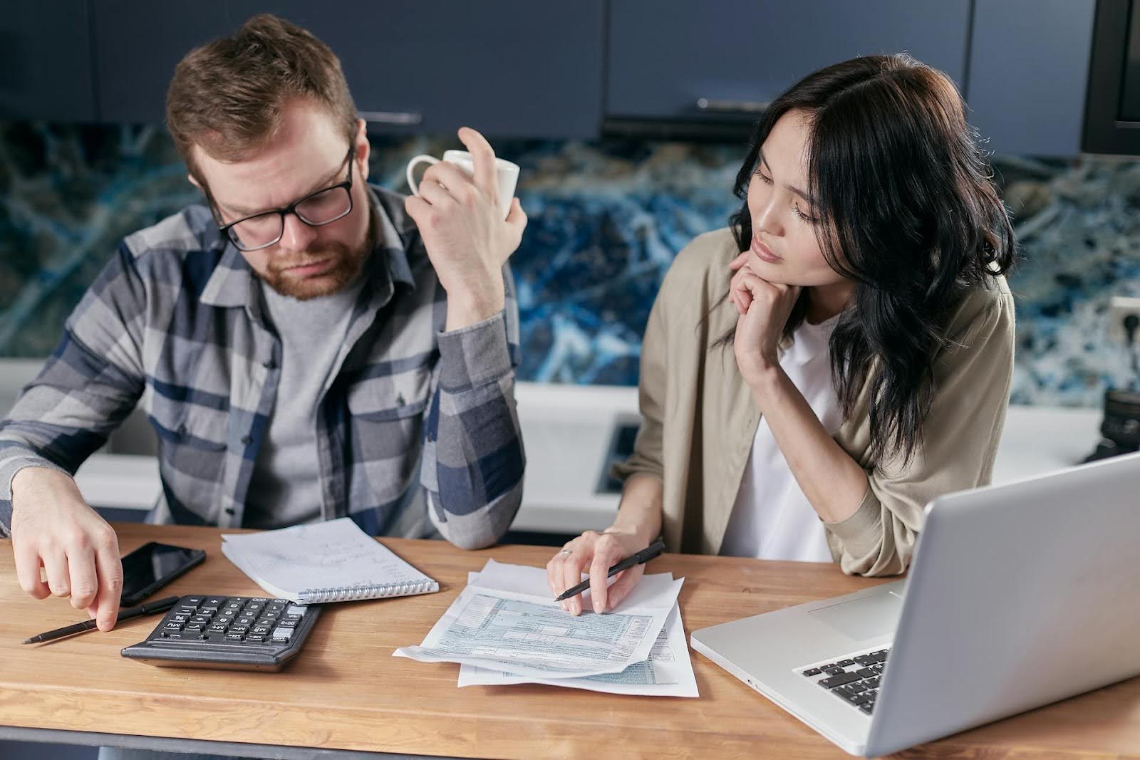 Two people looking at their business debt.