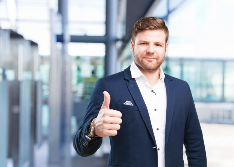 A confident man gives a thumbs up after successfully freeing himself from business debt.