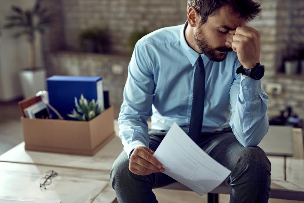 A man struggling with business debt.