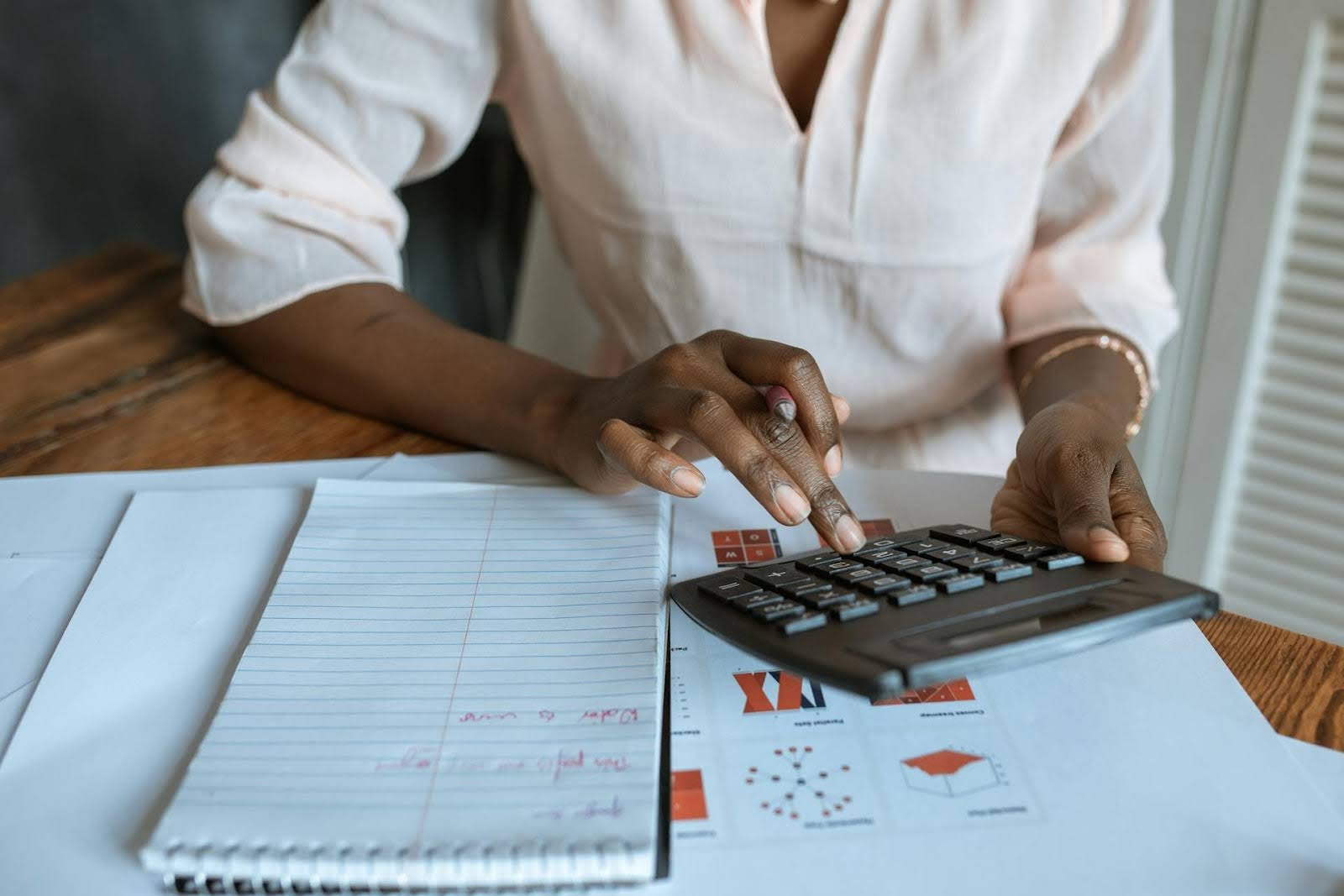 A woman calculating her MCA payments.