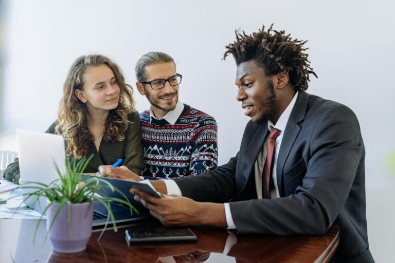 Two people working with their negotiator on debt settlement.