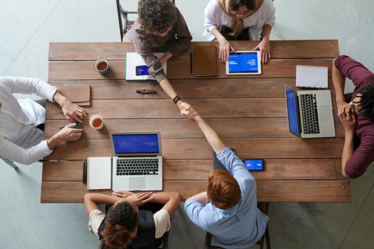 Group of colleagues working on rebuilding business with a profit-first mindset.