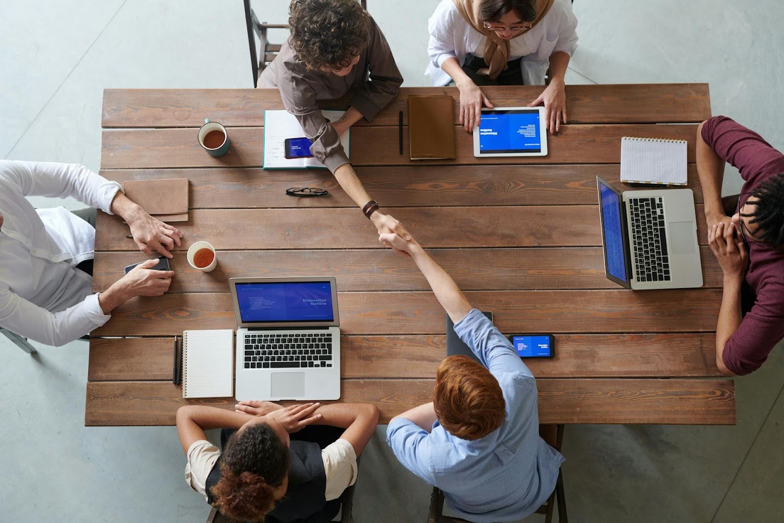 Group of colleagues working on rebuilding business with a profit-first mindset.