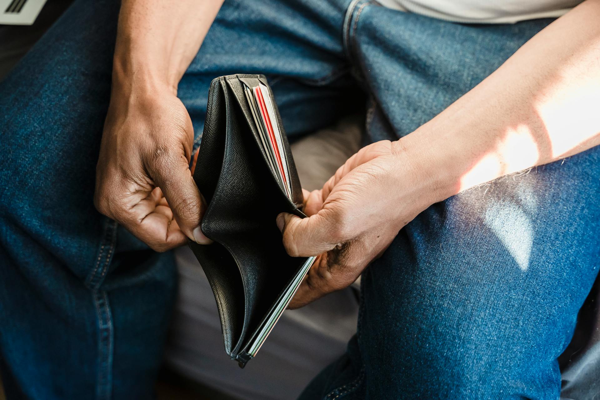 A man holding an empty wallet.