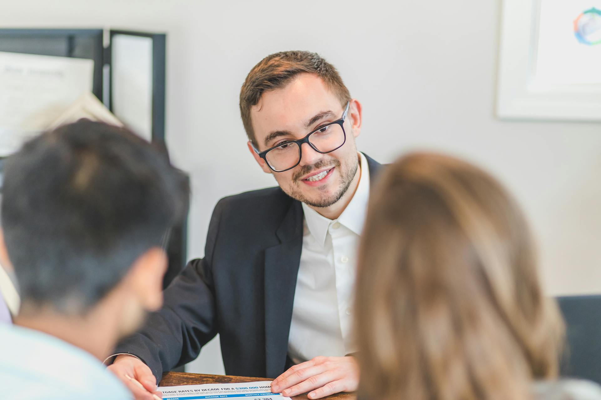 A couple talking to a creditor in a meeting.