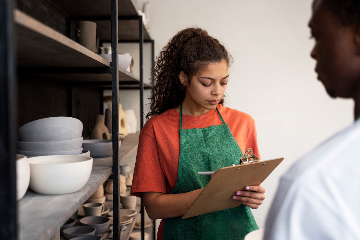 A ceramic shop owner looking at her balance sheets.