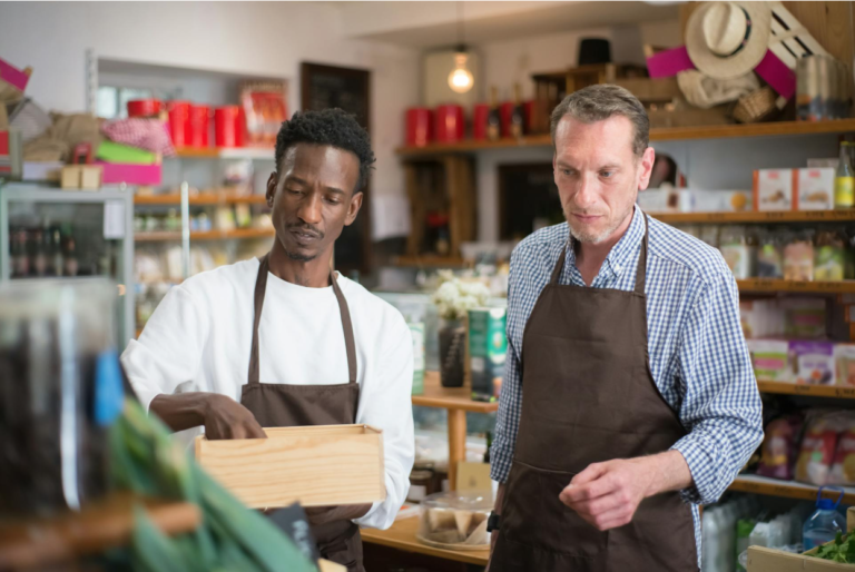 Two business owners working in their shop.