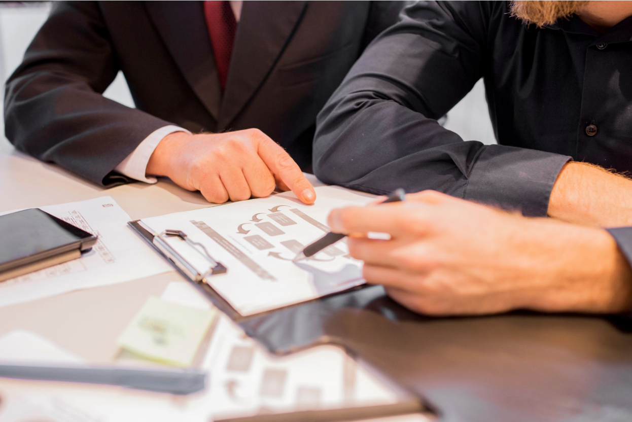 Two colleagues researching whether the debt settlement company has the right strategy.